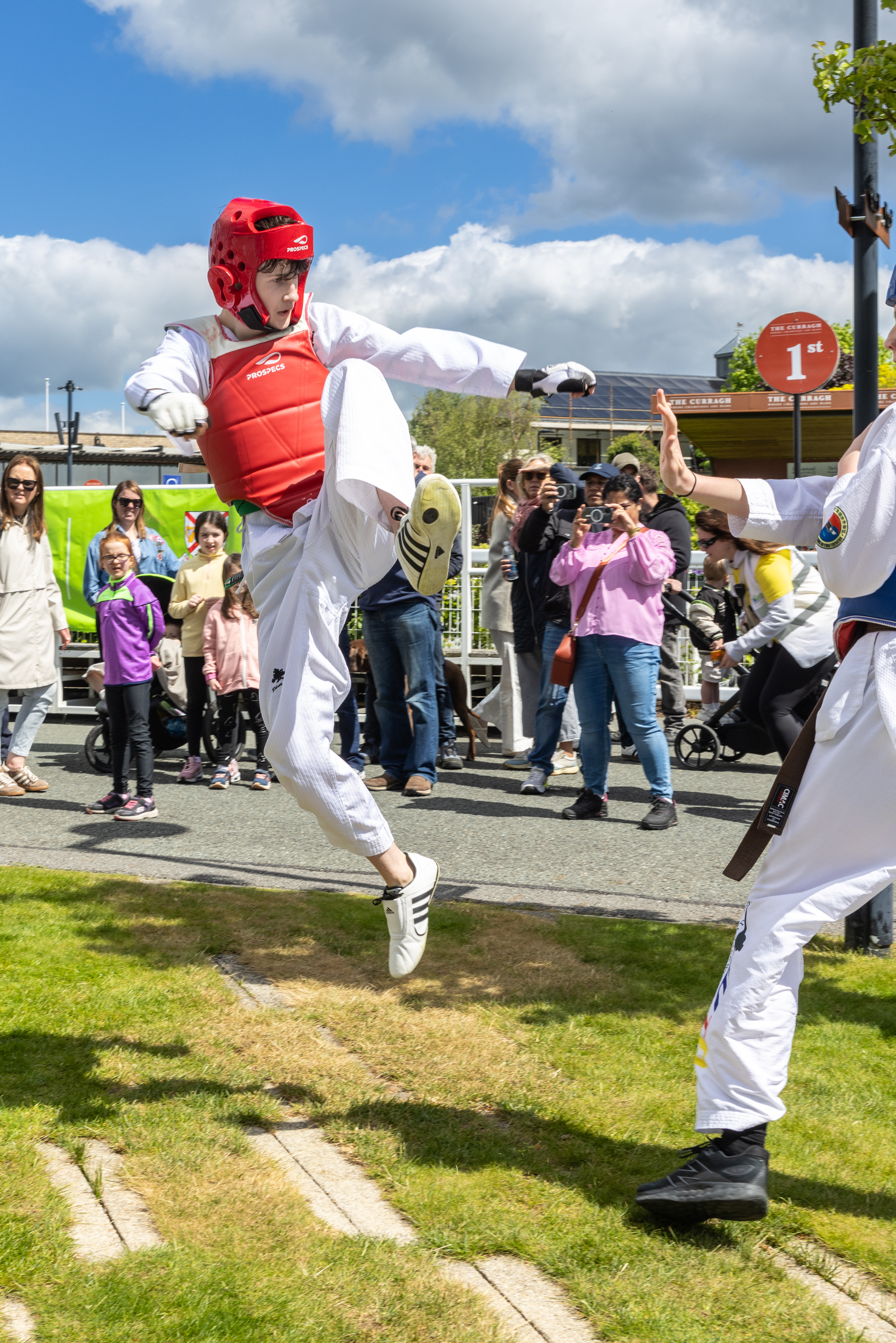 Person kicking in the air, preforming Taekwondo. 